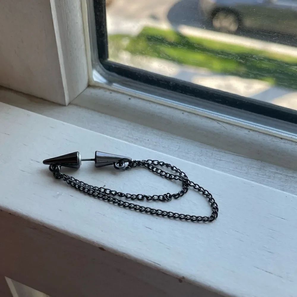 One black colored chain earring
